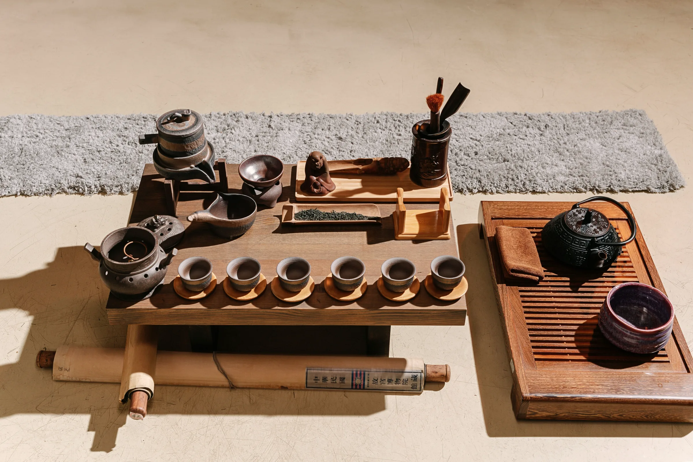 A lidded tea bowl on a wooden table beside a river
