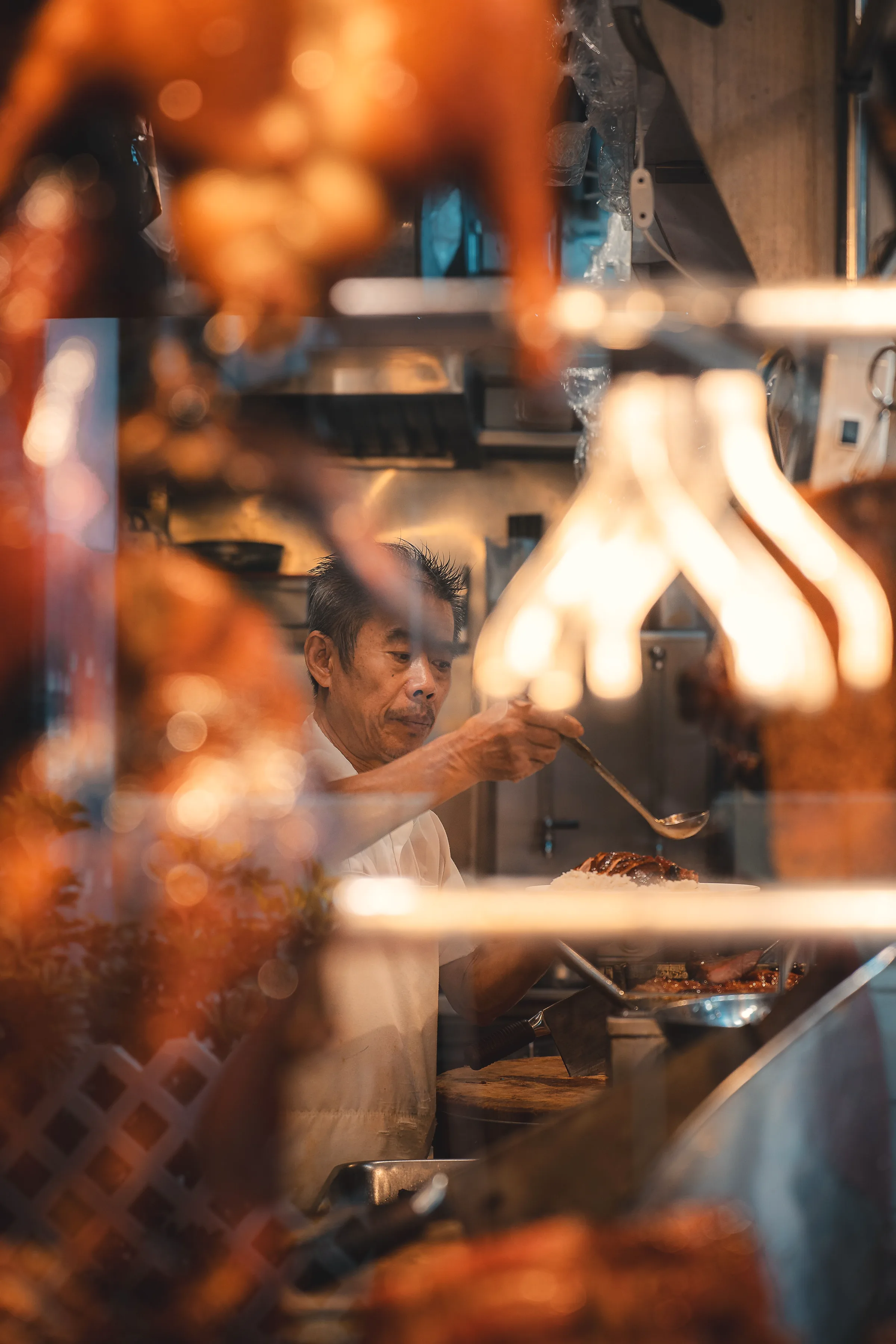 Glazed roast meats hanging in a shop window
