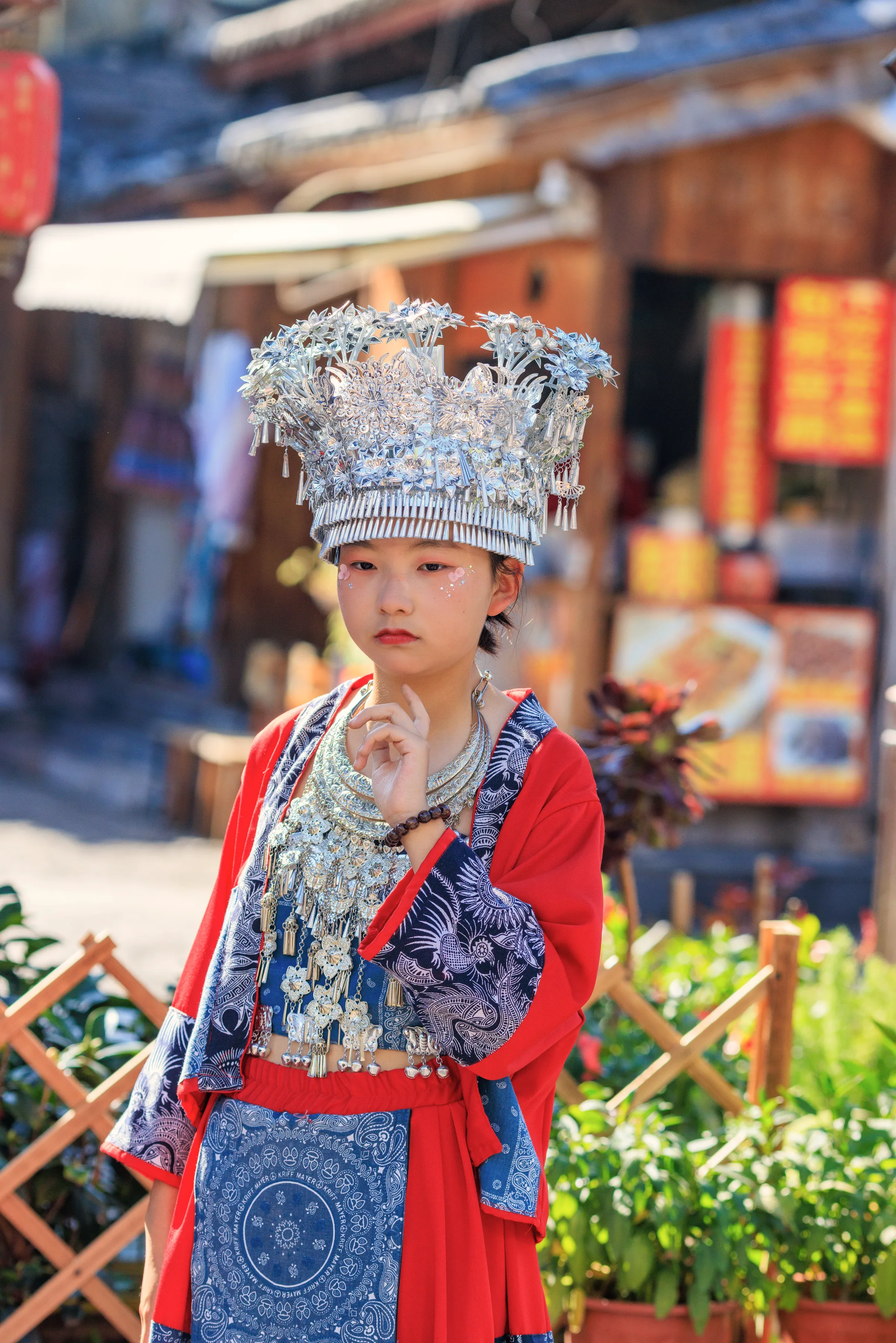 An ornate silver headdress with layered horn and flower forms
